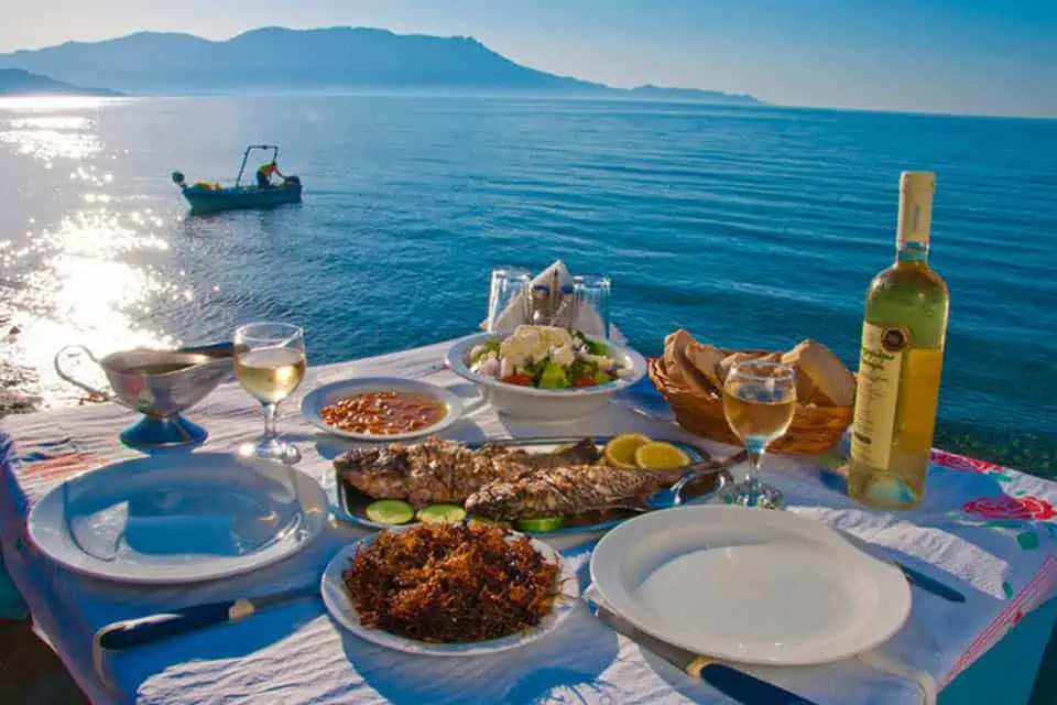 a table near the sea with cretan cuisine and wine