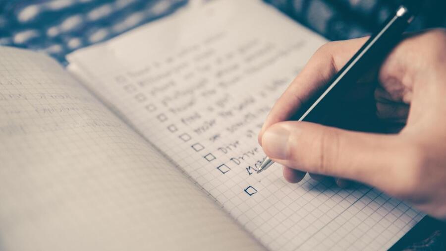 an open notepad with a checklist.